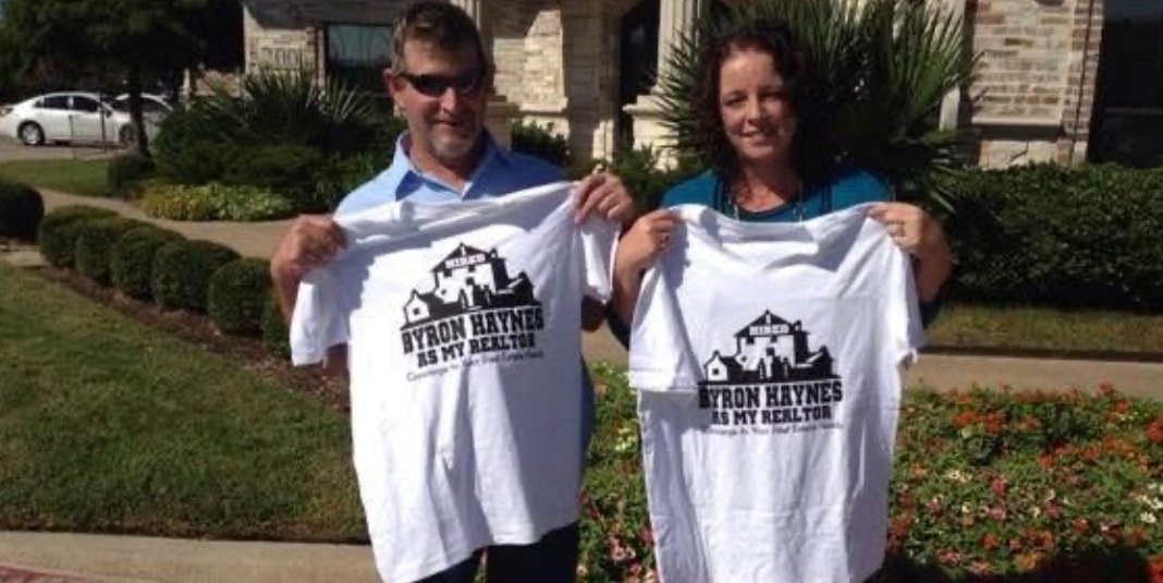 Clients proudly holding Byron Haynes As My Realtor t-shirts