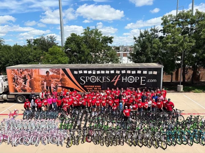 Byron Haynes volunteering with Spokes 4 Hope — donating bikes to kids in the community